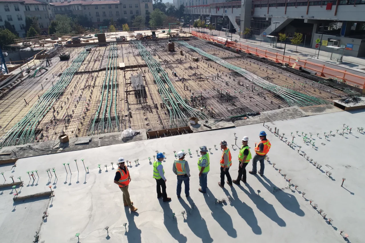Occupational Safety Training. A group of workers are stanfing on the rooftop at a construction site.